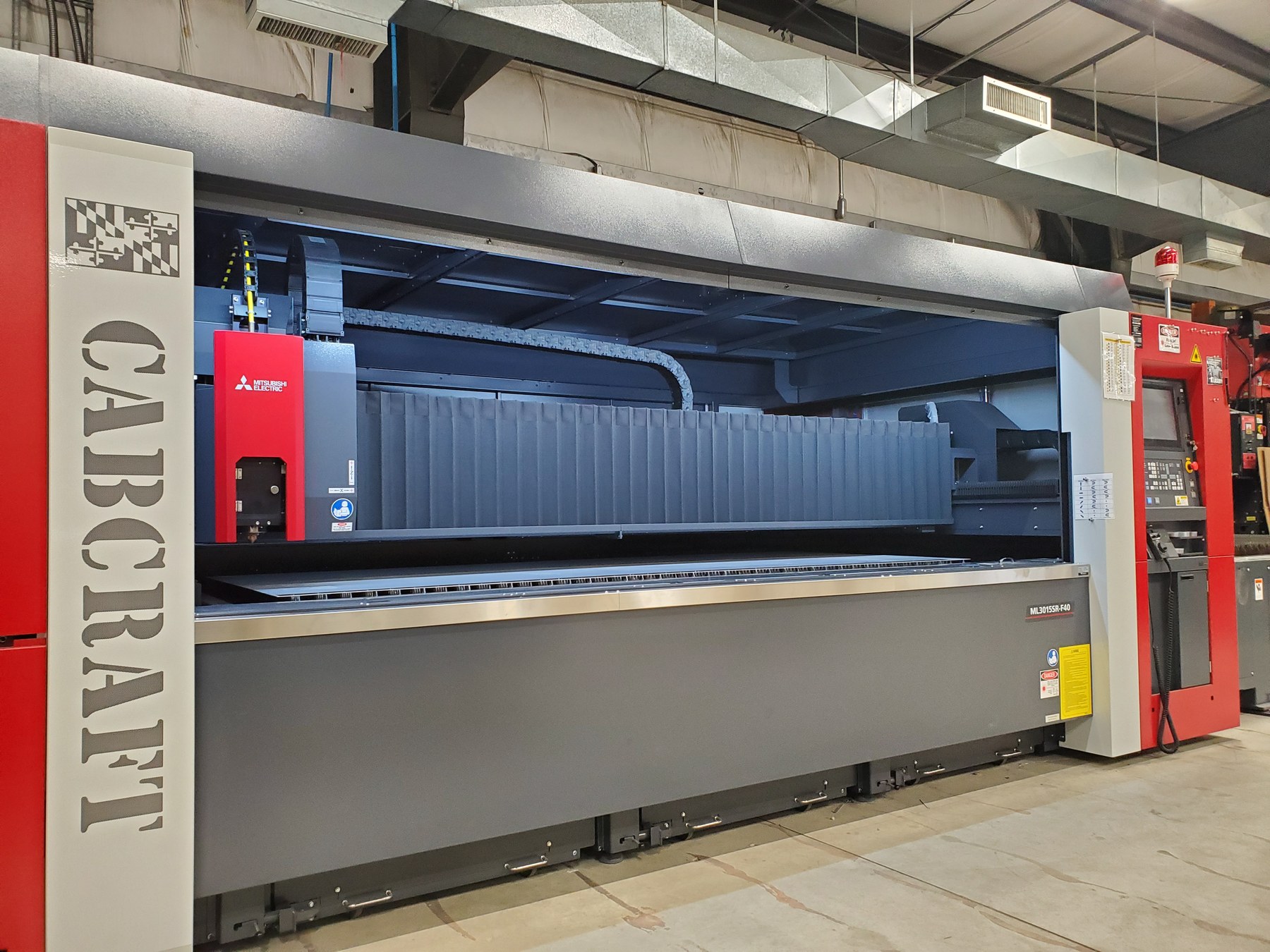 Fiber laser cutting stainless steel panels at CabCraft