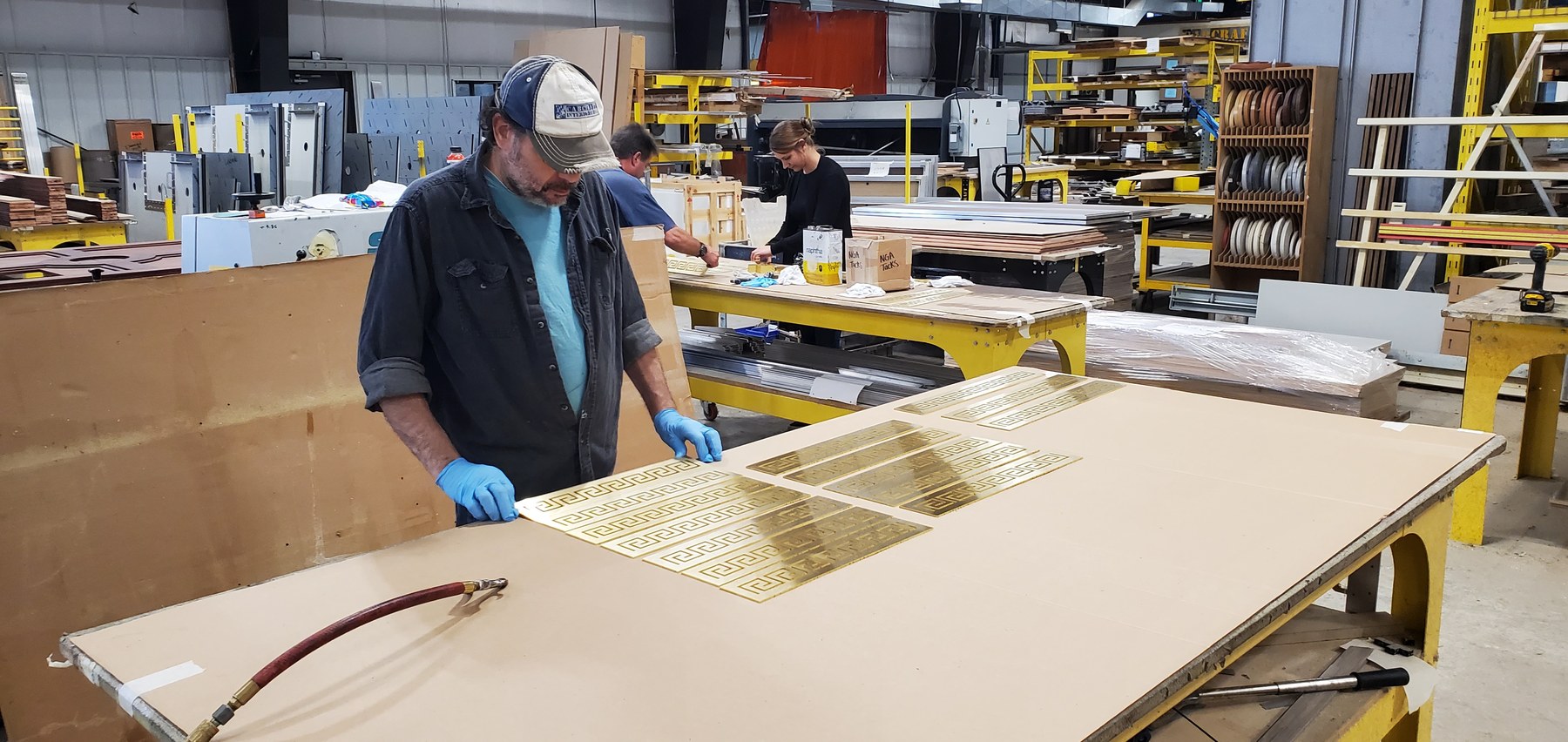 Laying out elevator panels on the bench at CabCraft