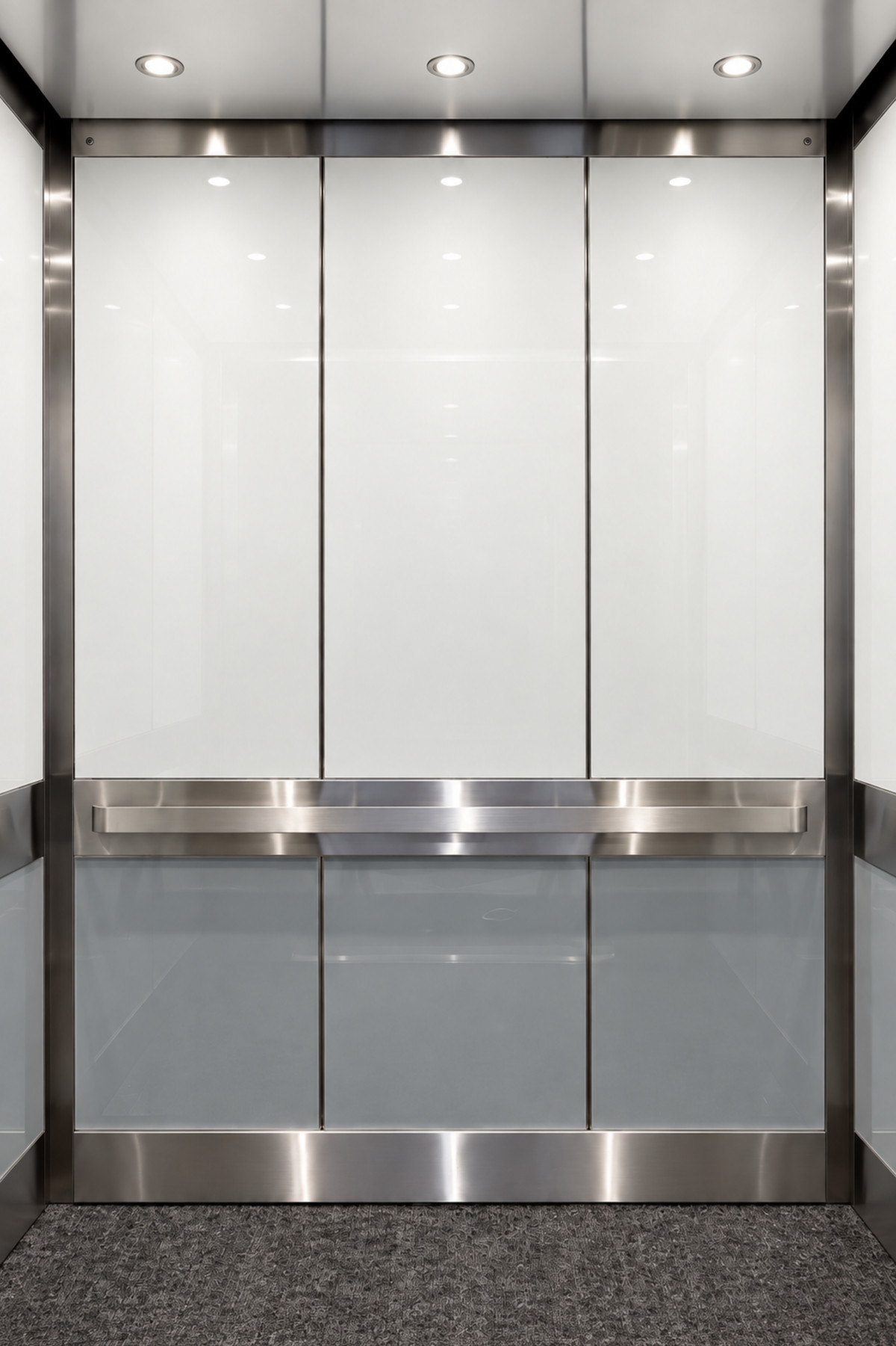 Elevator cab interior with white back-painted glass panels and stainless steel trim