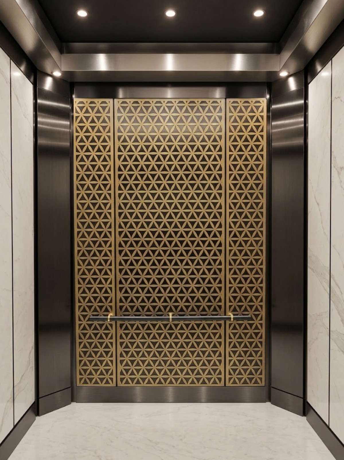 Elevator cab interior with sculpted brass decorative metal panels and black stainless steel trim